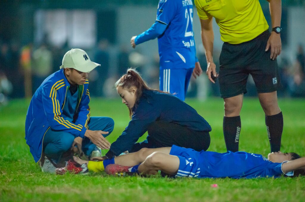 Medical team attends to an injured soccer player in Hà Nội, Vietnam.