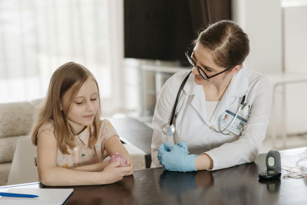 A doctor and a young girl during a pediatric check-up, fostering healthcare and trust.