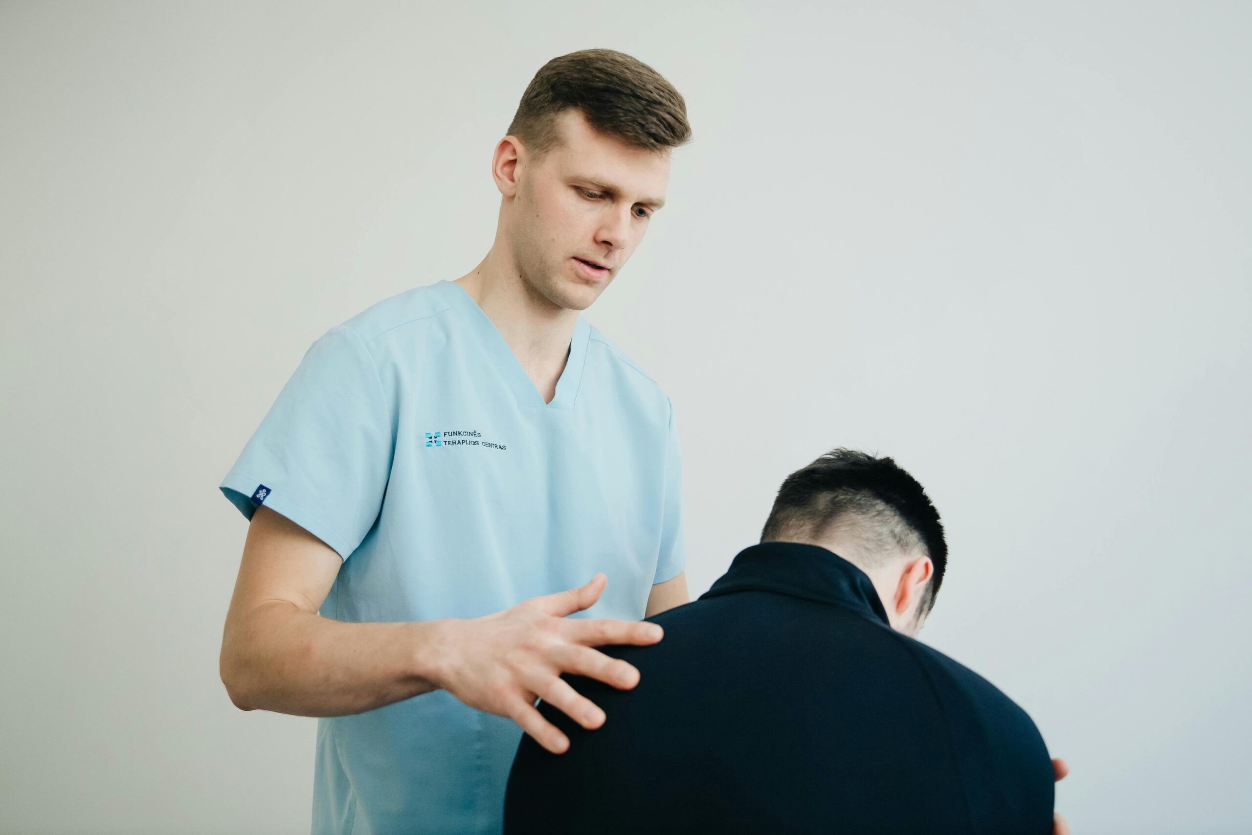pexels-photo-20860581-20860581 A physiotherapist assessing a patient's posture indoors, showing support and expertise.