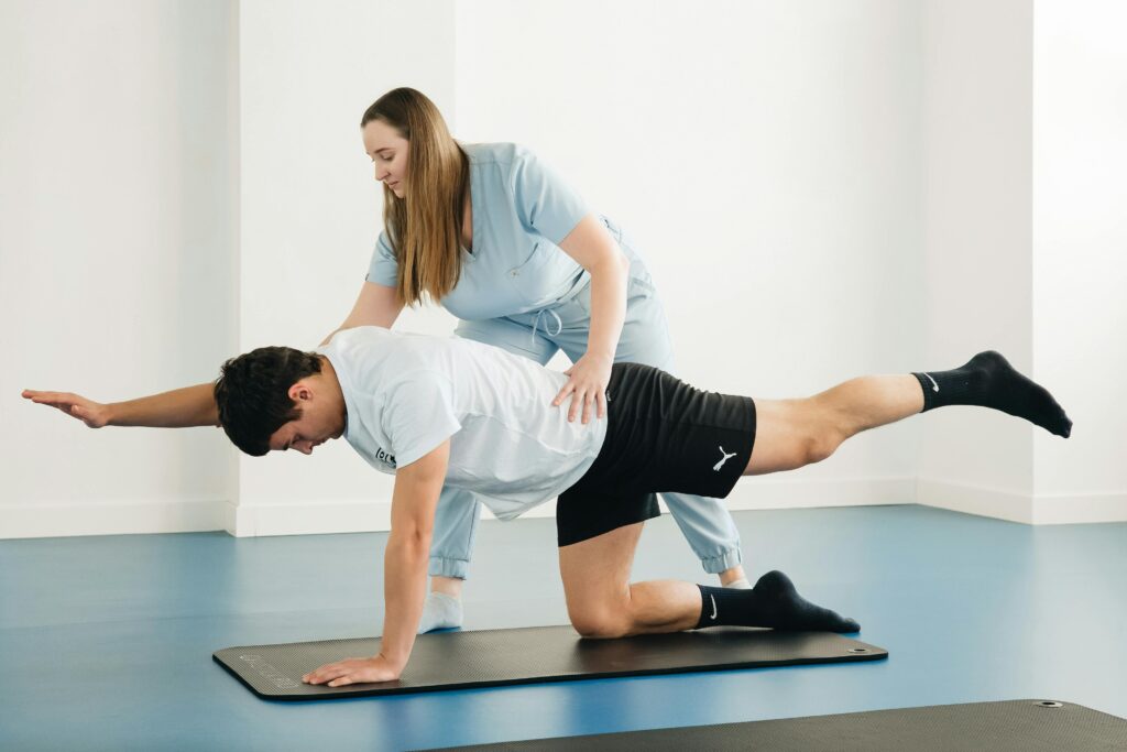 A physiotherapist assists a patient with exercises in a modern clinic setting.